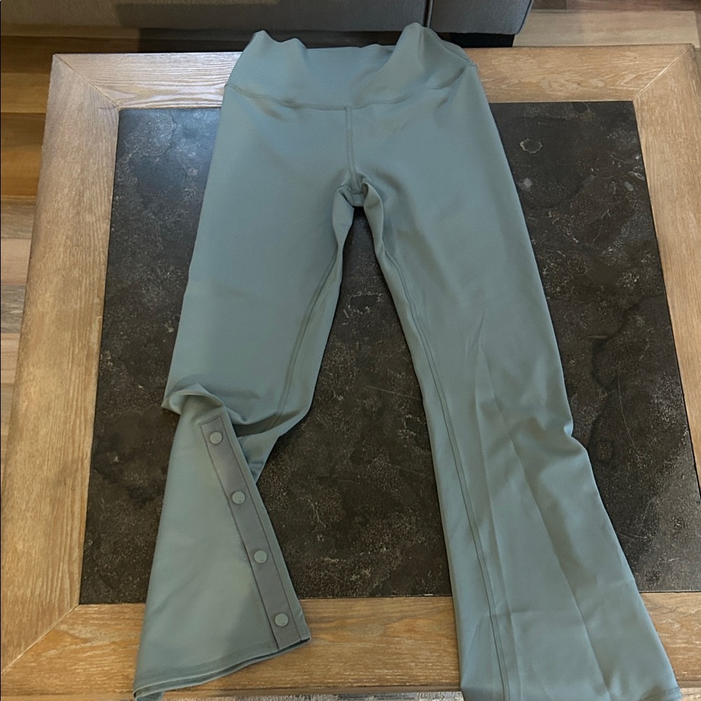 Alo Yoga boot cut leggings with button snaps at the bottom